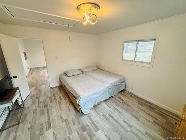 280 Hall Hill Road Ancram, NY 12502 - Photo 17 of 19 a bedroom with a bed and wooden floor