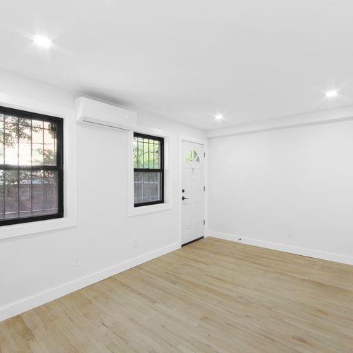 87 Adelphi Street Brooklyn, NY 11205 - Photo 12 of 35 an empty room with windows