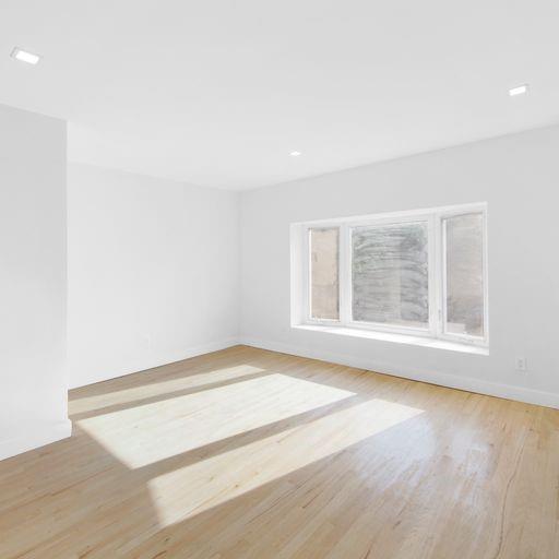 87 Adelphi Street Brooklyn, NY 11205 - Photo 13 of 35 a view of an empty room with wooden floor and a window