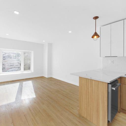 87 Adelphi Street Brooklyn, NY 11205 - Photo 15 of 35 a view of an empty room with wooden floor and a window