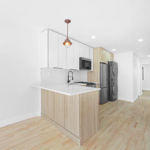 87 Adelphi Street Brooklyn, NY 11205 - Photo 17 of 35 a kitchen with stainless steel appliances a sink stove and refrigerator