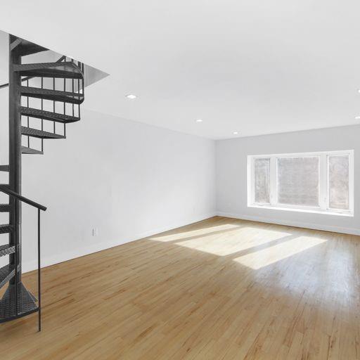 87 Adelphi Street Brooklyn, NY 11205 - Photo 23 of 35 a view of an empty room with wooden floor and fan