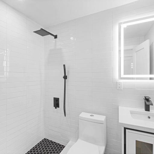 87 Adelphi Street Brooklyn, NY 11205 - Photo 26 of 35 a bathroom with a toilet a sink a window and vanity