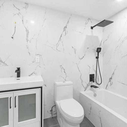 87 Adelphi Street Brooklyn, NY 11205 - Photo 35 of 35 a bathroom with a sink a toilet and a tub