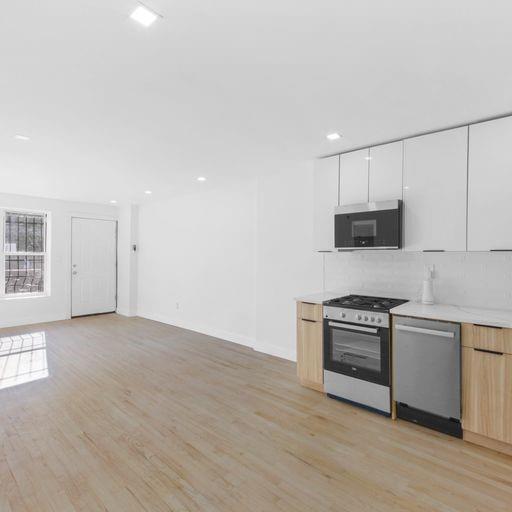 87 Adelphi Street Brooklyn, NY 11205 - Photo 6 of 35 a view of a kitchen with a sink stove and wooden floor