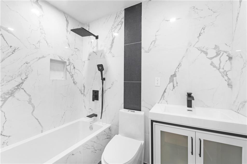 87 Adelphi Street Brooklyn, NY 11205 - Photo 8 of 35 a bathroom with a sink toilet and shower