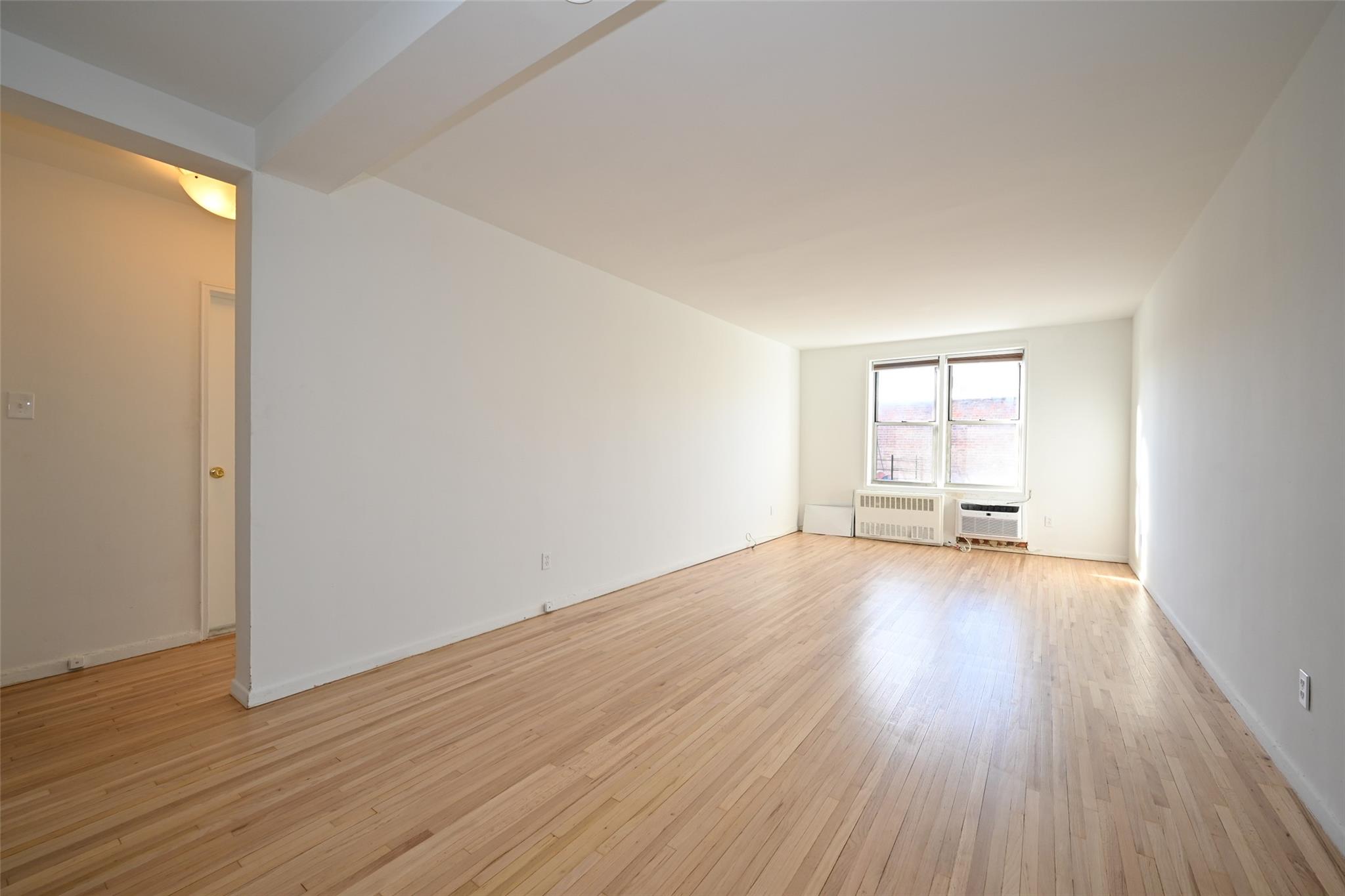 6535 Broadway, Unit 6A Bronx, NY 10471 - Photo 4 of 26 Spacious and well-lit living room with versatile dining nook
