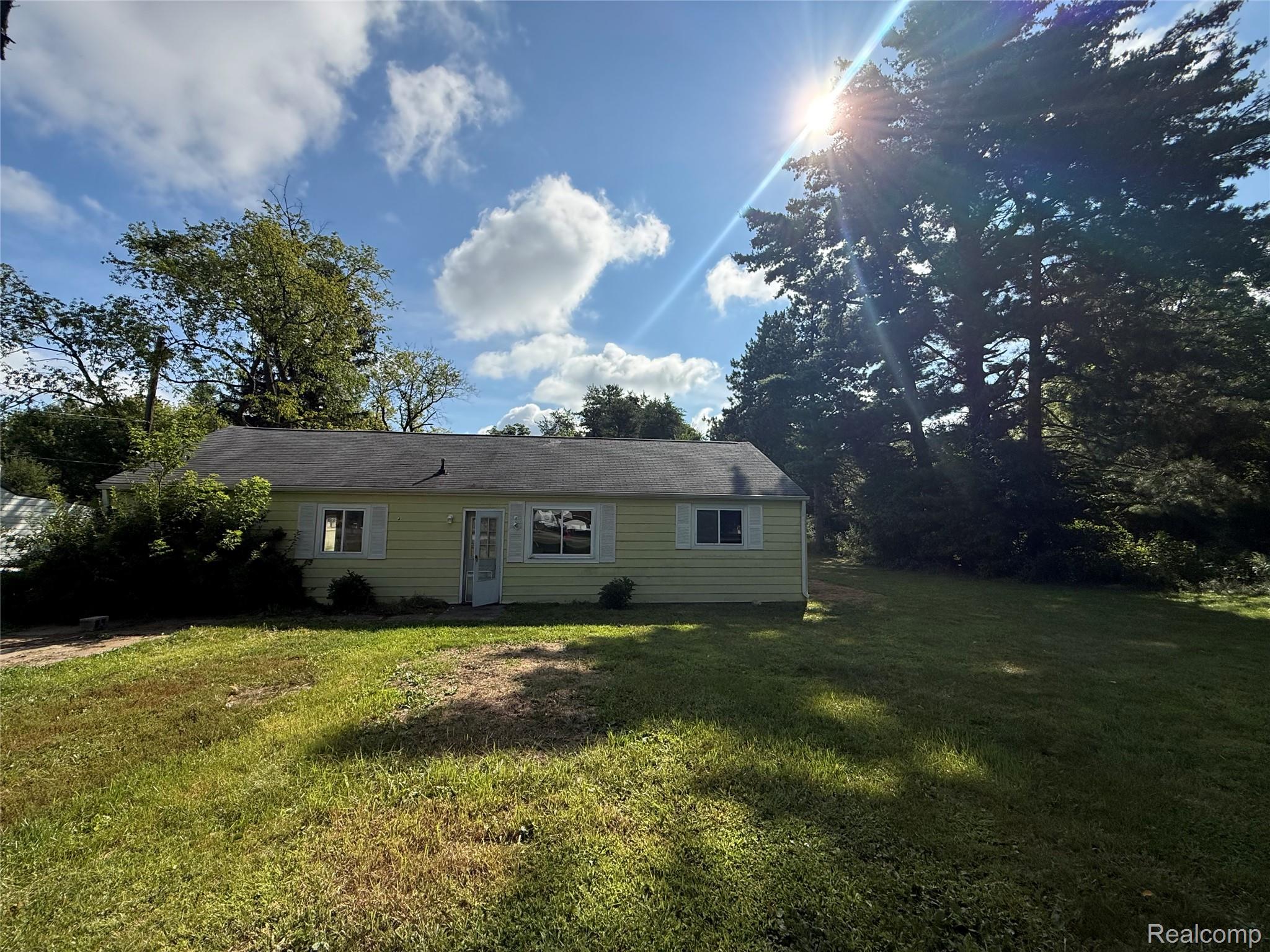 1139 Baldwin Road Lapeer, MI 48446 - Photo 2 of 10 1139 Baldwin Rd. Yellow siding exterior with white window shutters