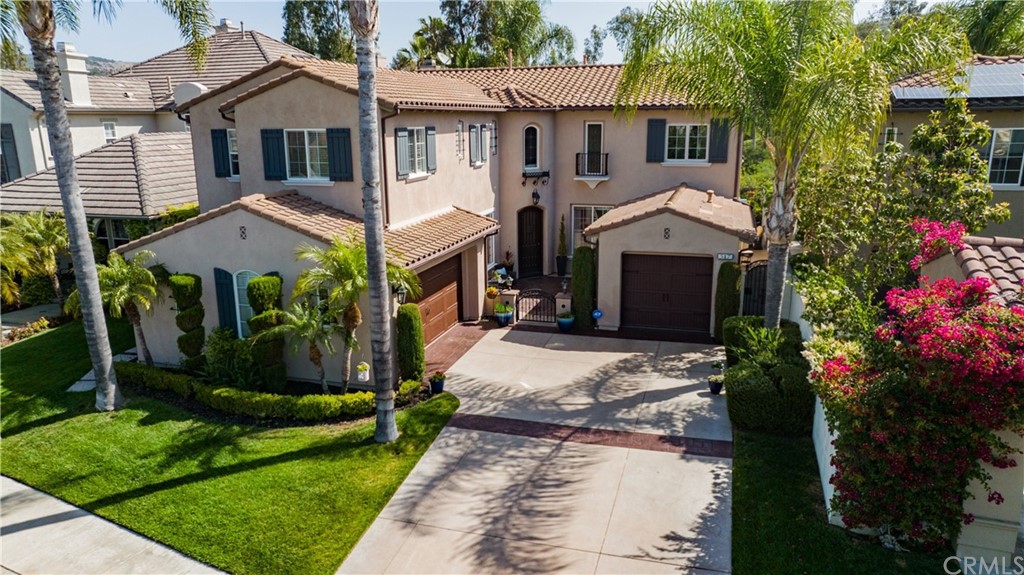 front view of house with a yard and potted plants
