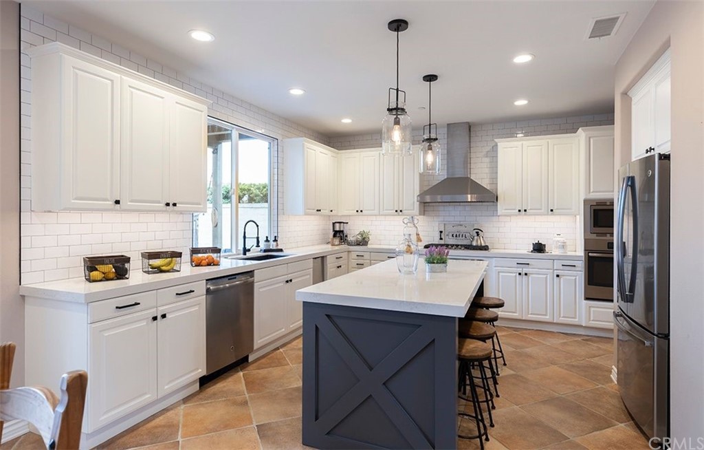 517 Via El Risco San Clemente, CA 92673 - Photo 11 of 51 a kitchen with stainless steel appliances kitchen island granite countertop a sink refrigerator and cabinets