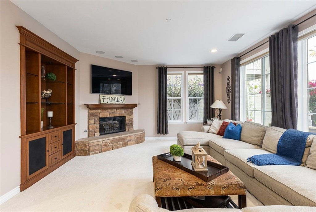 517 Via El Risco San Clemente, CA 92673 - Photo 18 of 51 a living room with furniture a fireplace and a flat screen tv
