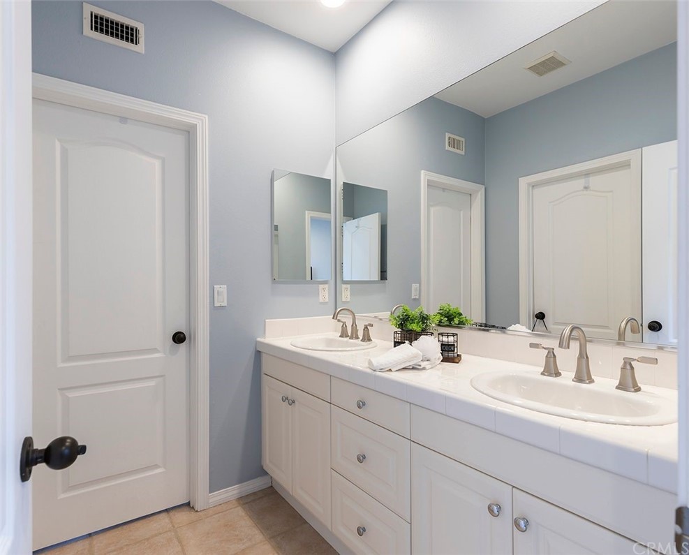517 Via El Risco San Clemente, CA 92673 - Photo 22 of 51 a bathroom with double sink and a mirror