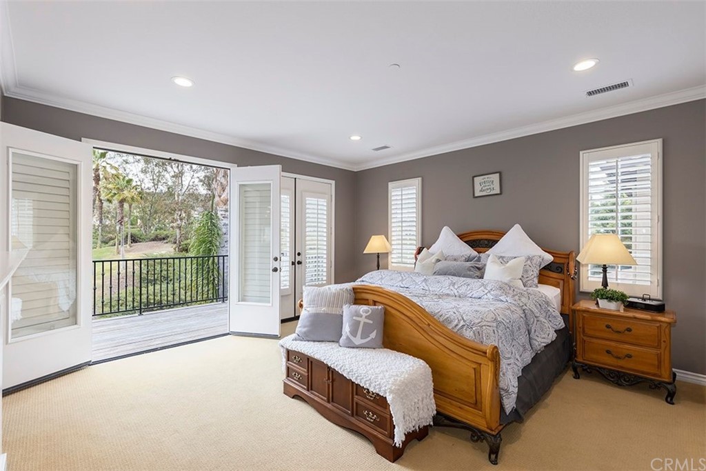 517 Via El Risco San Clemente, CA 92673 - Photo 31 of 51 a spacious bedroom with a bed and a large window