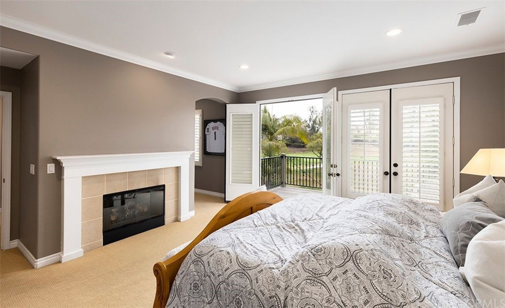 517 Via El Risco San Clemente, CA 92673 - Photo 32 of 51 a bedroom with a large bed and a fireplace
