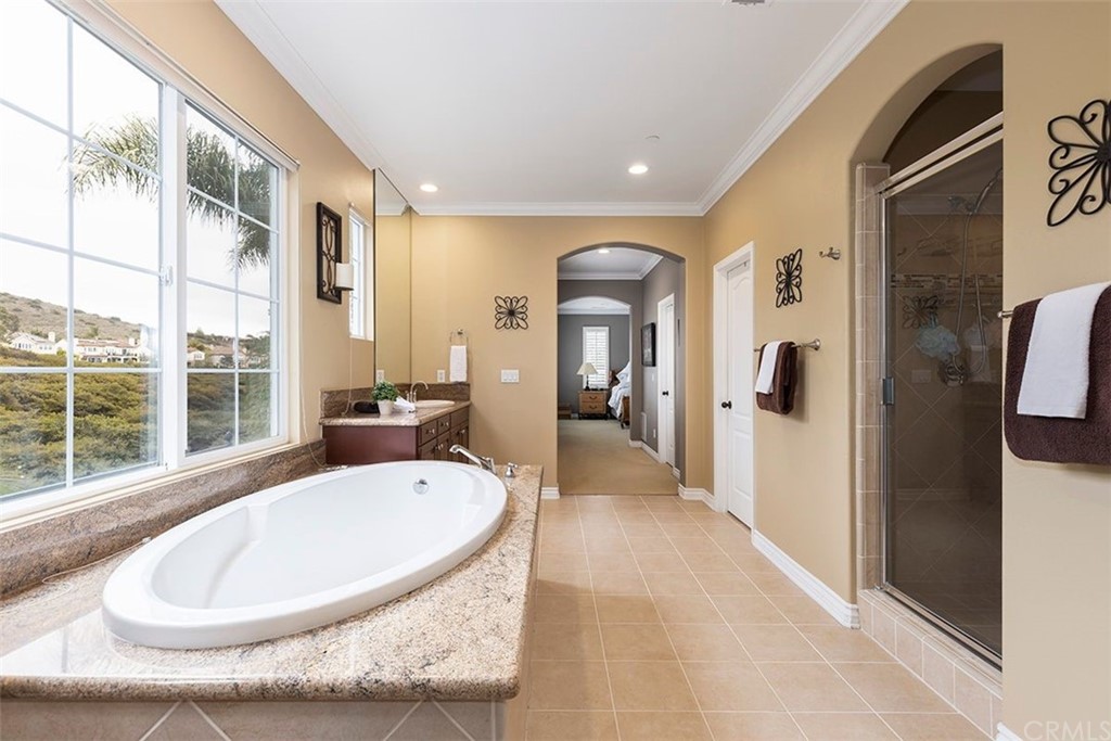 517 Via El Risco San Clemente, CA 92673 - Photo 33 of 51 a en suite bathroom with a granite countertop tub and a large window