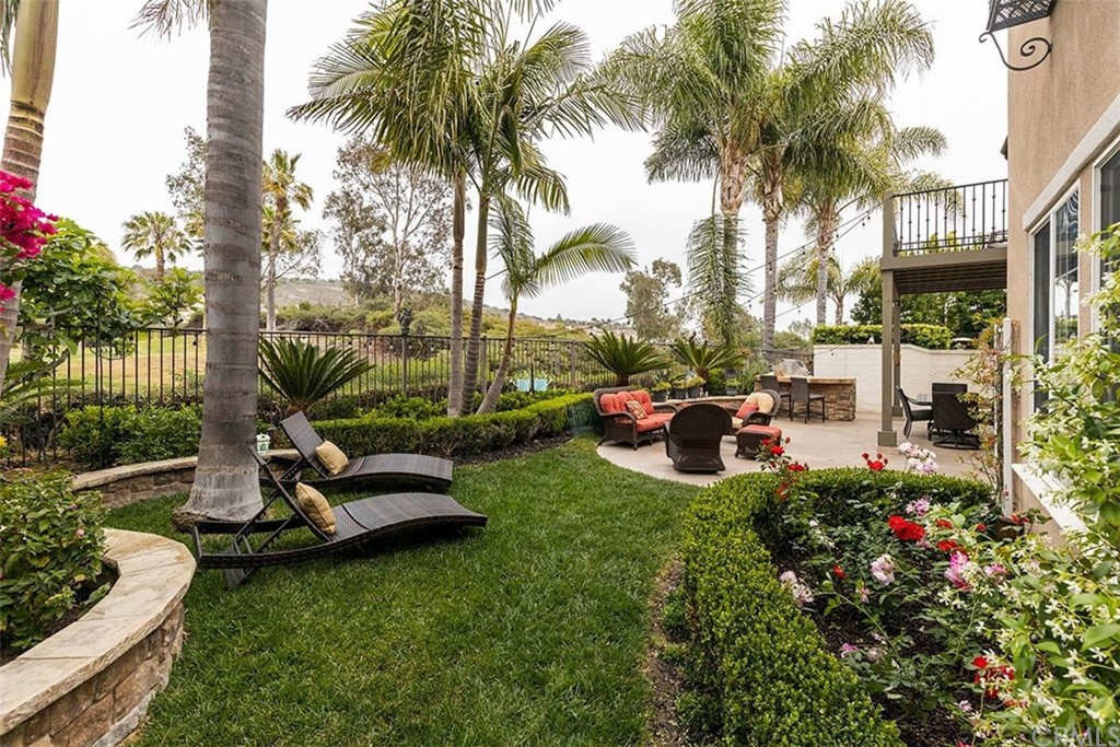 517 Via El Risco San Clemente, CA 92673 - Photo 38 of 51 a view of a patio with couches table and chairs potted plants and palm tree
