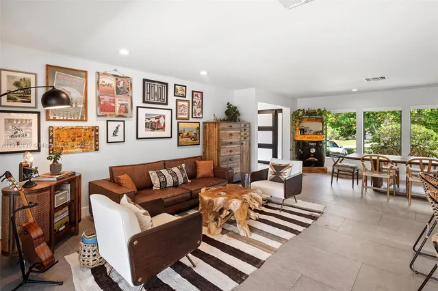 a view of a dining room with furniture and a floor to ceiling window