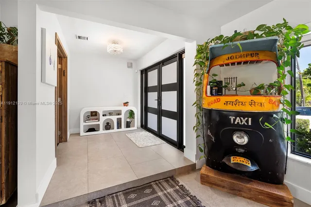 a kitchen with stainless steel appliances granite countertop a refrigerator a sink dishwasher a stove and white cabinets with wooden floor