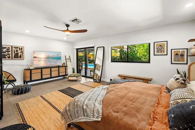 a bedroom with a large bed and a window