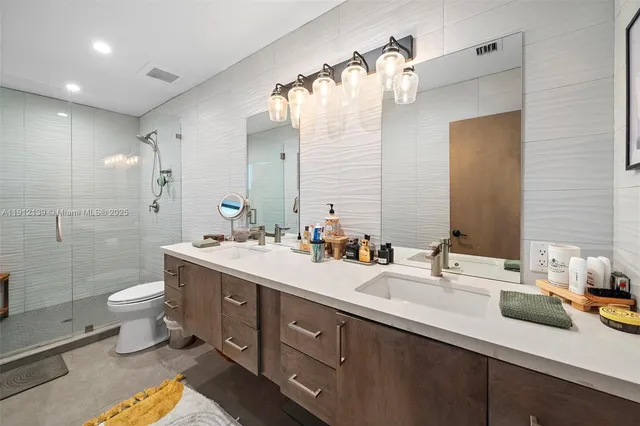 a spacious bathroom with a sink a toilet and shower