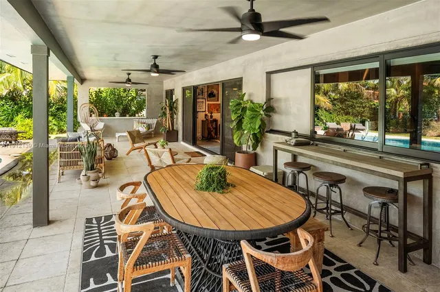 a living room with lots of furniture and a large window