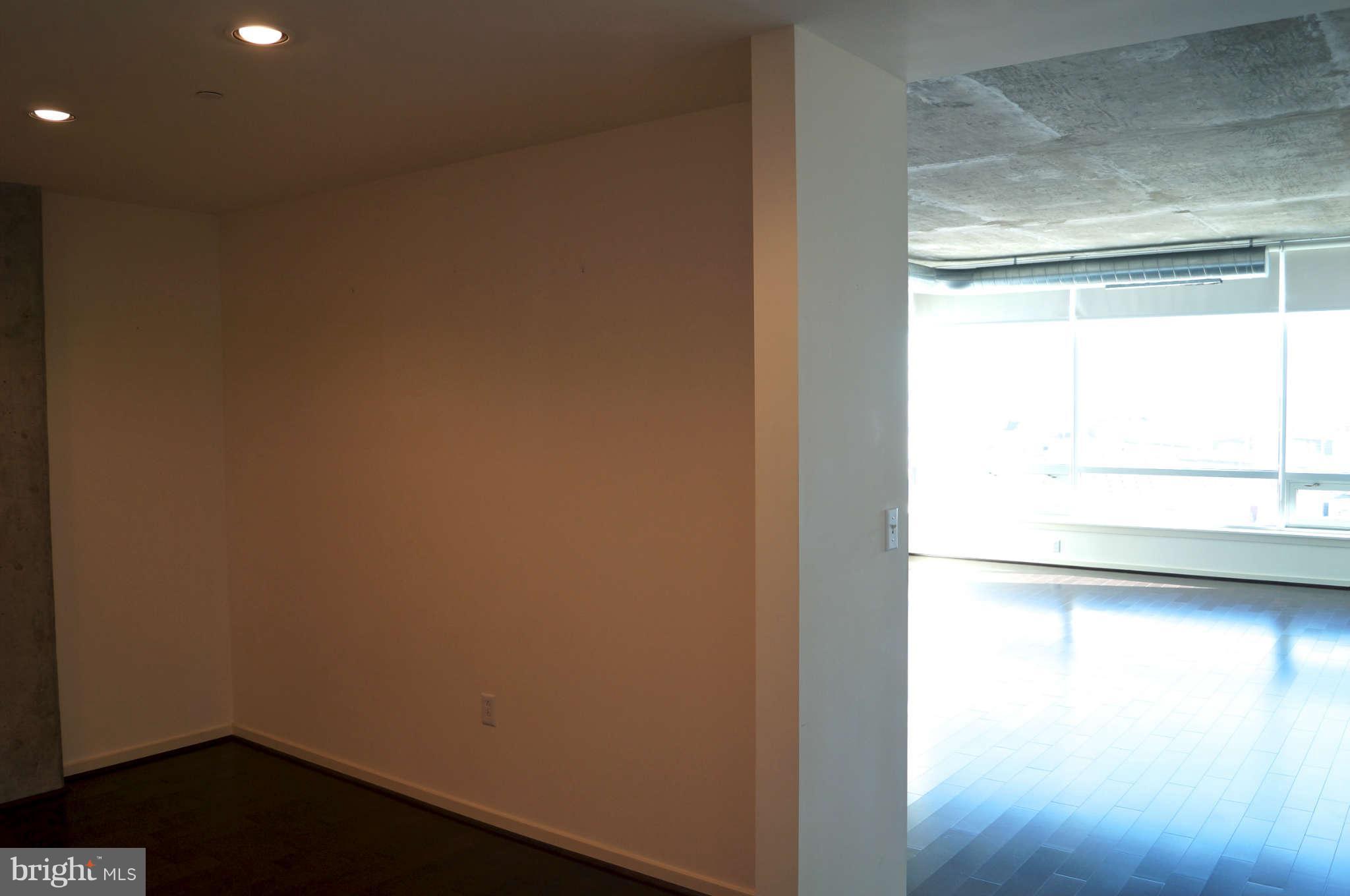 1200 Steuart Street, Unit 822 Baltimore, MD 21230 - Photo 17 of 30 a view of a small space with wooden floor and a window