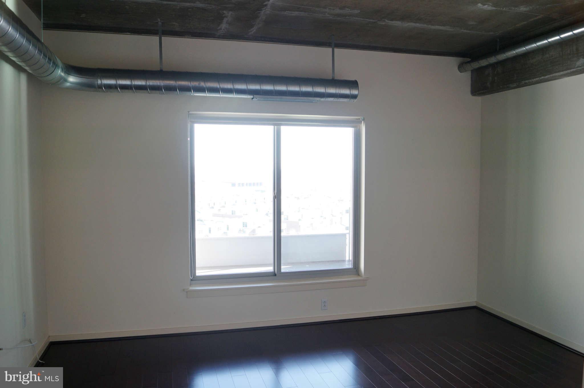 1200 Steuart Street, Unit 822 Baltimore, MD 21230 - Photo 18 of 30 a view of a small space with wooden floor and a window