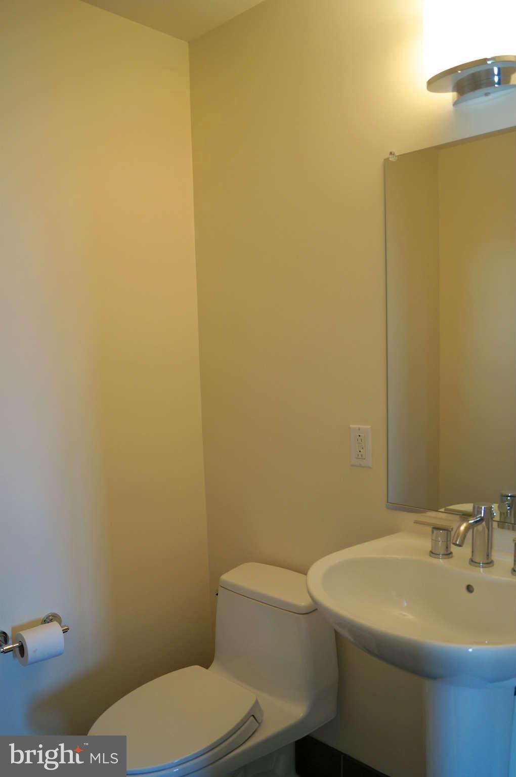 1200 Steuart Street, Unit 822 Baltimore, MD 21230 - Photo 6 of 30 a bathroom with a sink a toilet and mirror