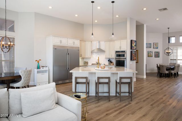 a living room with kitchen island furniture and a dining table with wooden floor