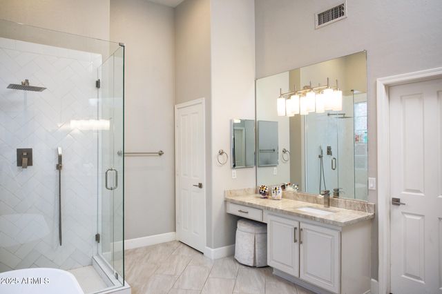 a bathroom with a double vanity sink mirror and shower