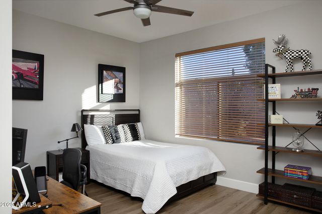 a bedroom with a bed a desk and chair