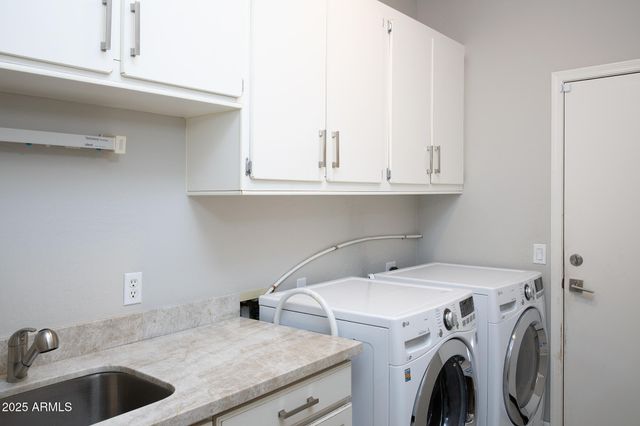 a view of storage and utility room with washer and dryer