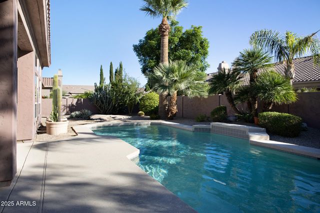 a view of a patio with a table and chairs and potted plants