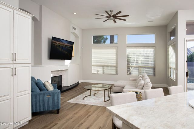 a living room with fireplace furniture and a flat screen tv