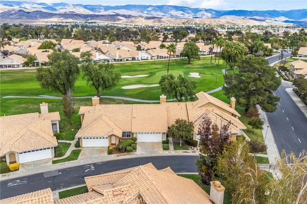 an aerial view of a house with yard swimming pool and outdoor seating