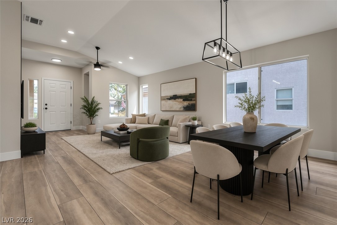 2139 Chapman Ranch Drive Henderson, NV 89012 - Photo 5 of 58 Virtually Staged Natural light illuminates this open-concept living and dining area, featuring sleek wood flooring and recessed lighting.