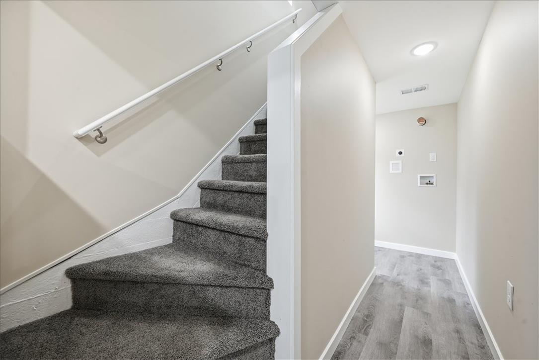 5641 North Coplay Road Whitehall, PA 18052 - Photo 18 of 68 Carpeted staircase ascends to the upper level, adjacent to a hallway with sleek flooring.