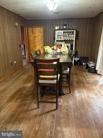 a reading room with furniture a window and a ceiling fan