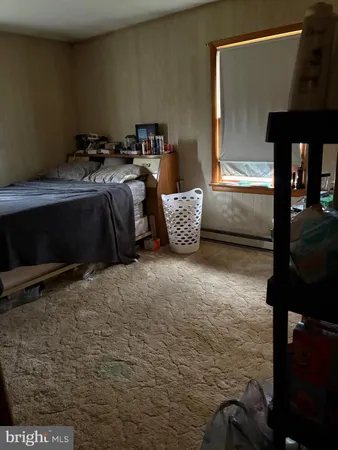 a bedroom with a bed and a lamp on table