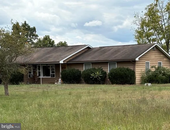 a view of a house with yard and sitting area
