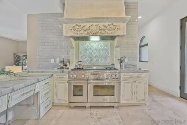 a kitchen with a refrigerator and a stove top oven