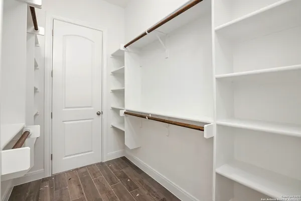 a view of walk in closet with empty racks