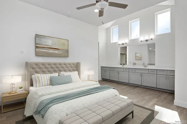a bedroom with a bed and ceiling cabinets