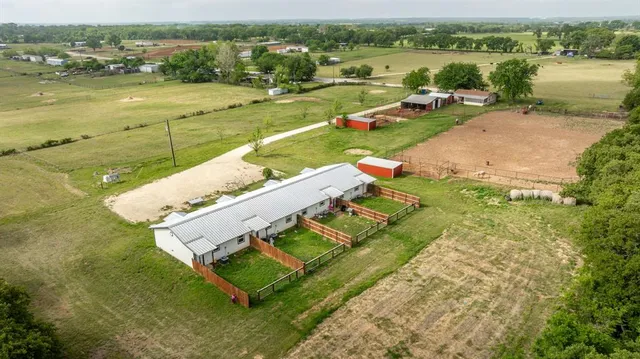 a view of backyard with deck and garden