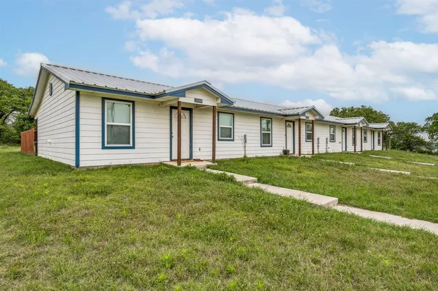 a view of a house with yard and front view of a house