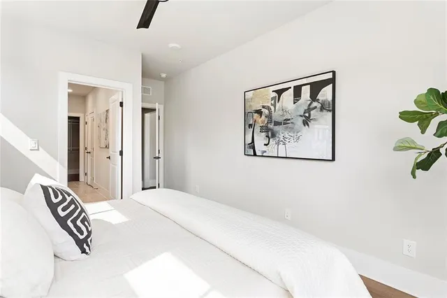 a bedroom with a bed and a painting on the wall