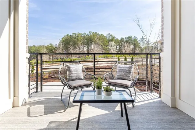 a view of a balcony with lake view and wooden floor