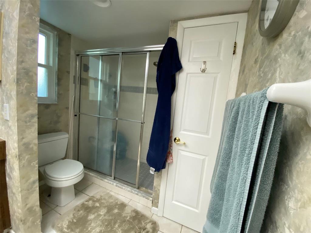 626 Orchid Lane Altamonte Springs, FL 32714 - Photo 13 of 24 a bathroom with a toilet and a shower