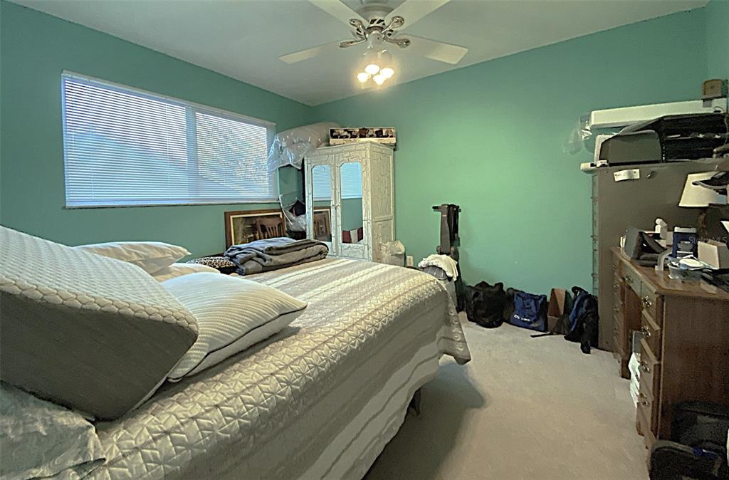 626 Orchid Lane Altamonte Springs, FL 32714 - Photo 14 of 24 a bedroom with a bed and a chandelier