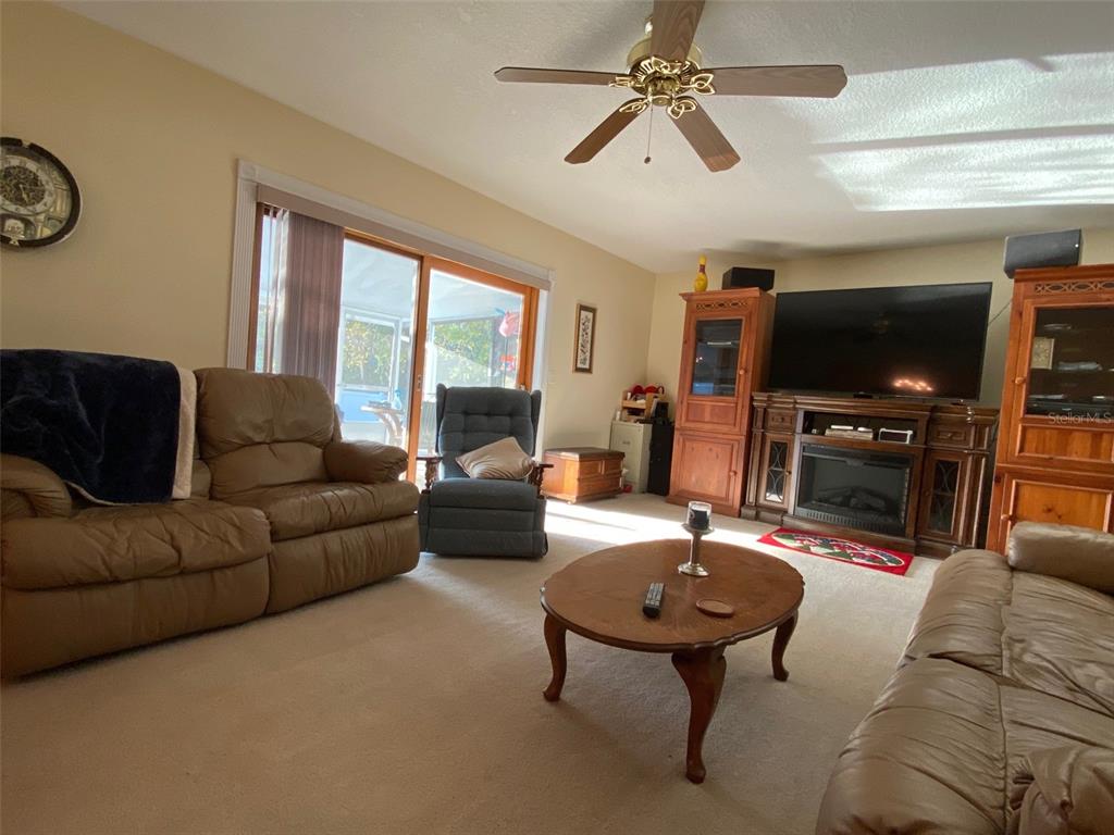 626 Orchid Lane Altamonte Springs, FL 32714 - Photo 5 of 24 a living room with furniture a flat screen tv and a large window
